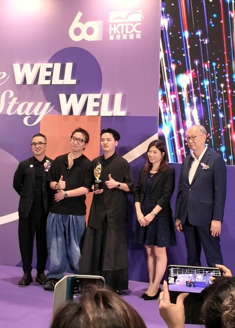 Godshand stylists receiving an award on stage in Hong Kong
