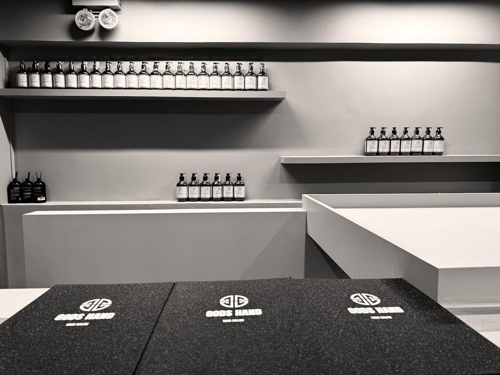 Reception counter and product shelves at Godshand Hair Salon